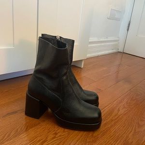 Black leather platform boots.